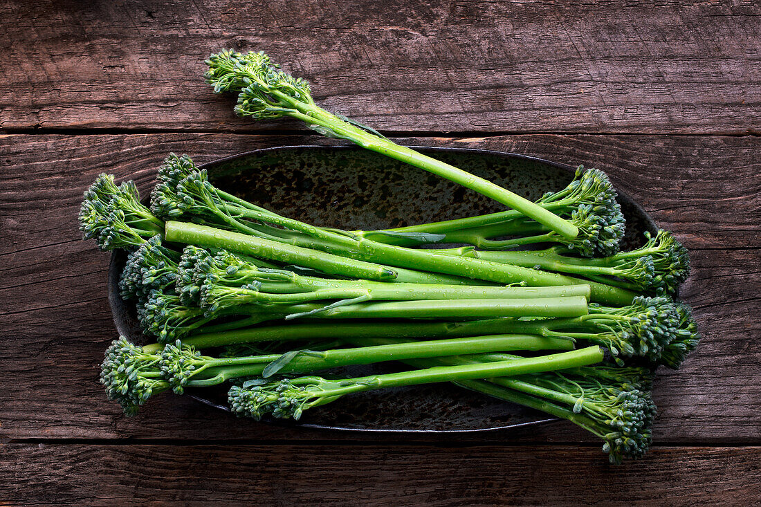 Broccolini on a wooden background