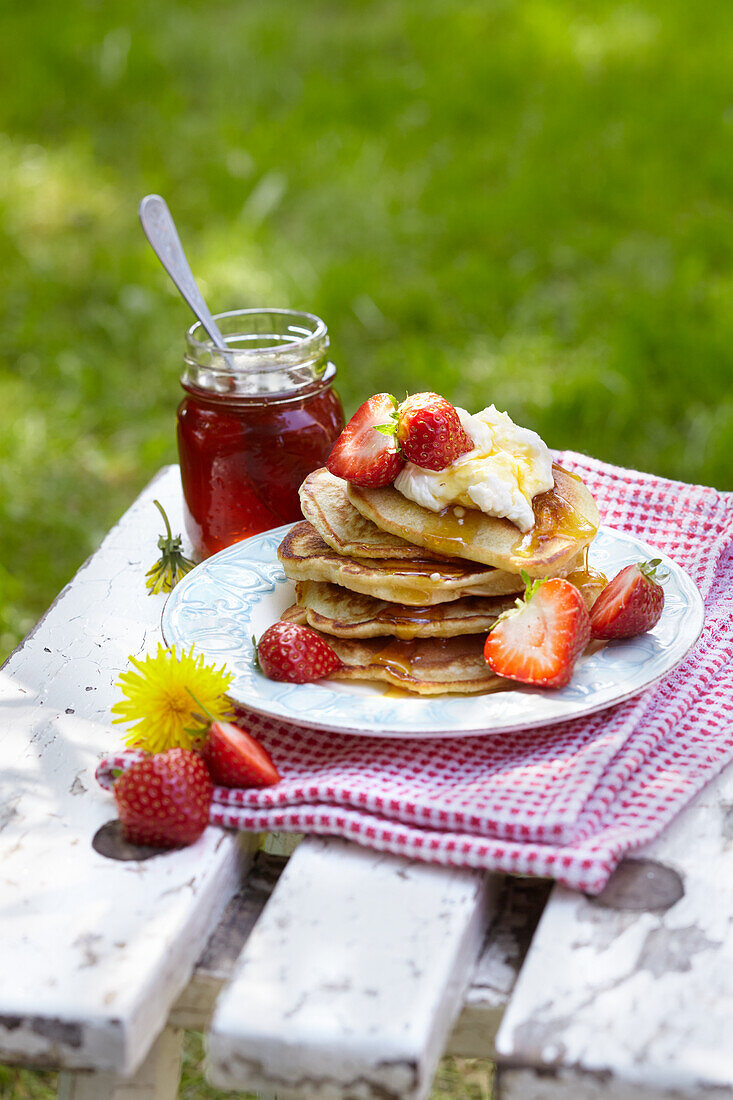 Pancakes with dandelion honey and strawberries