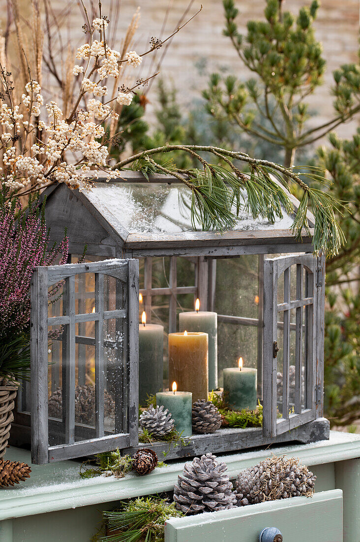 Mini greenhouse with burning candles