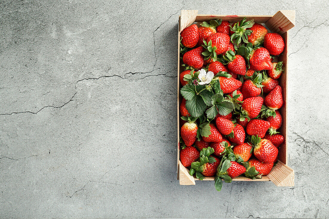 Ripe red strawberry in a wooden box