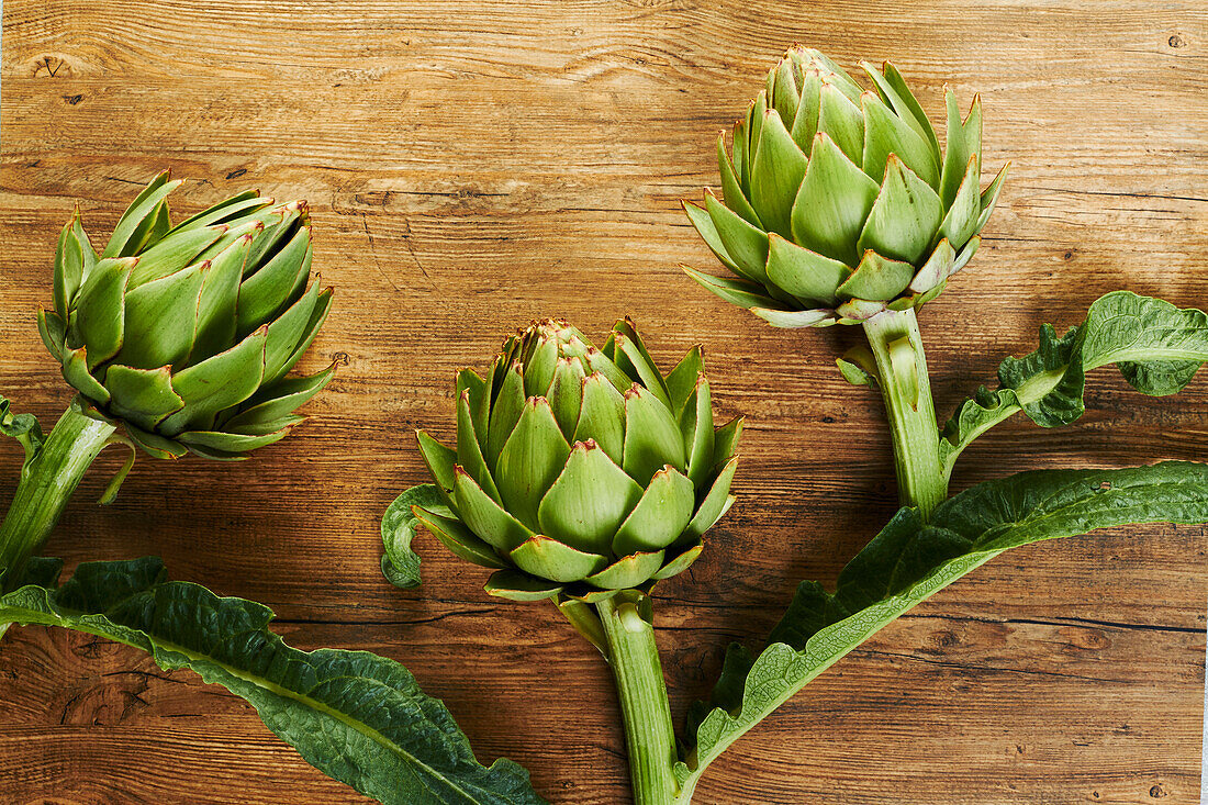 Fresh artichokes on a wooden background