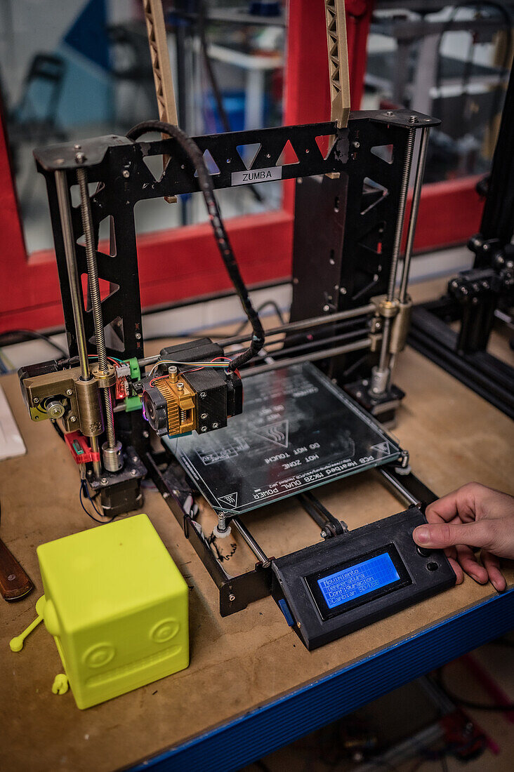 Man controlling a 3D printer
