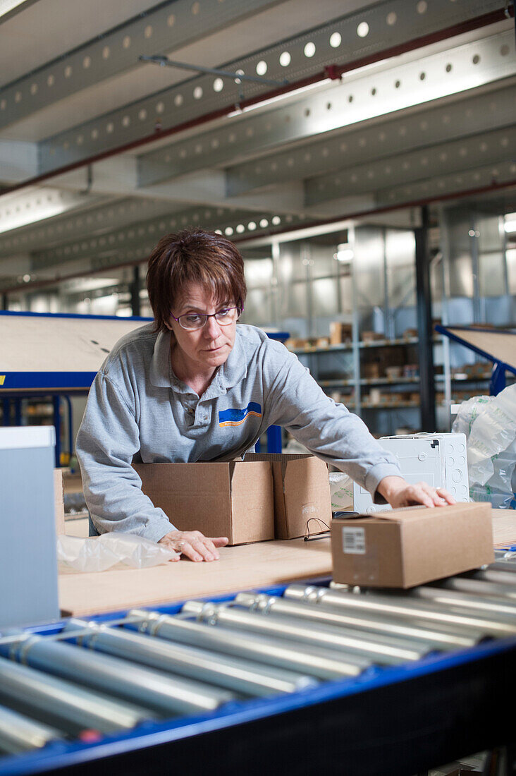 Worker packaging a customer's order in a warehouse