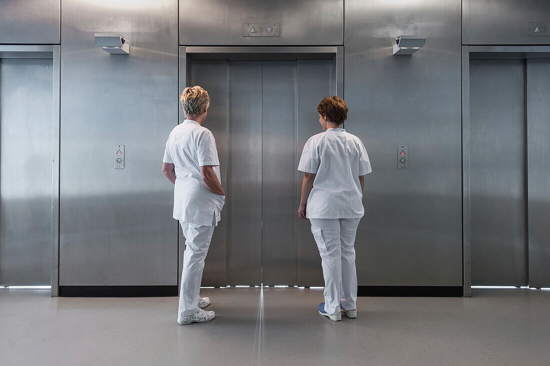 Nurses waiting for an elevator in a hospital