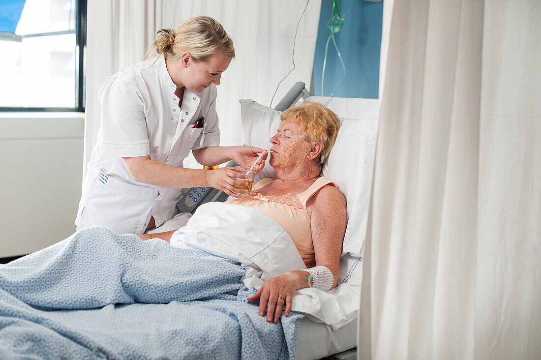 Nurse helping a patient to drink
