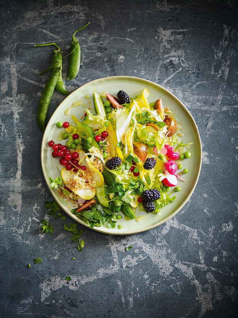 A summer salad with peas, blackberries and redcurrants