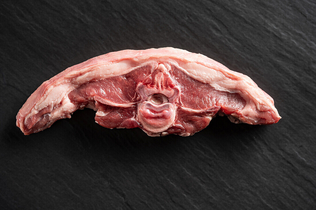 Raw lamb chop on a black background