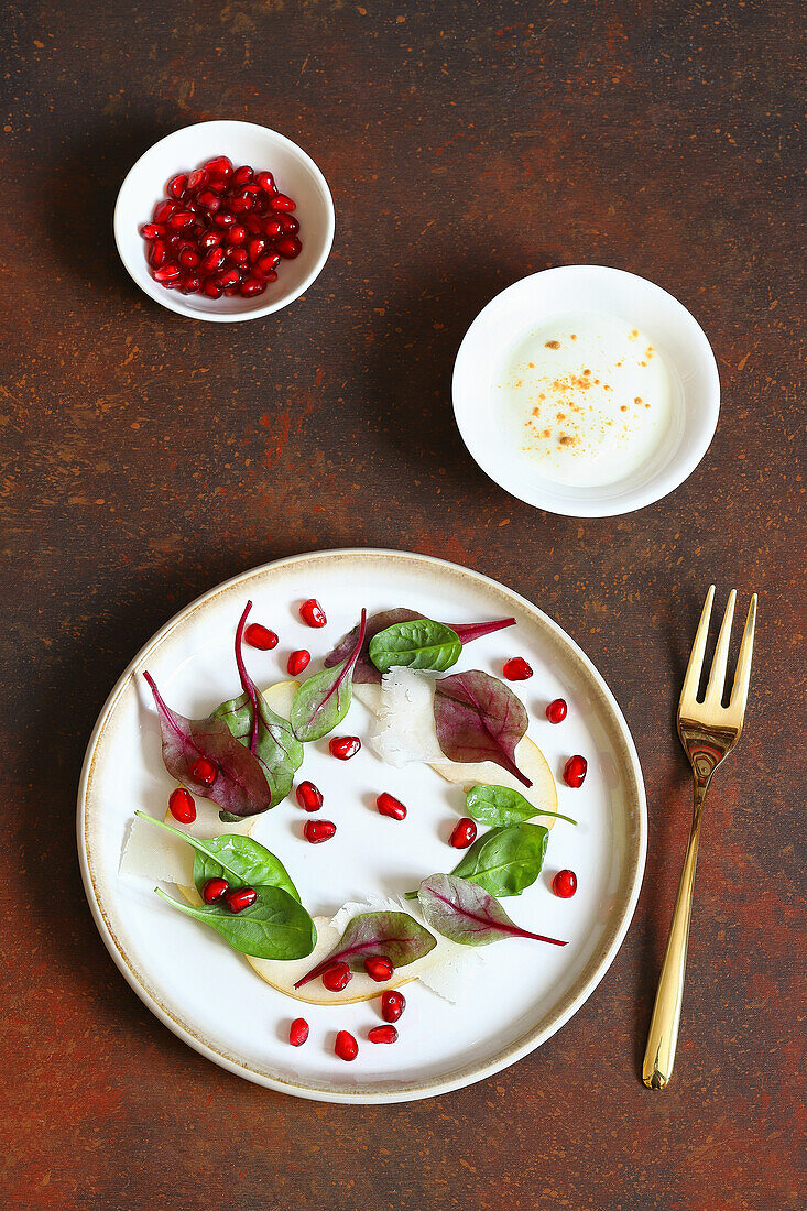 Leaf salad with pears, Parmigiano, and pomegranate seeds