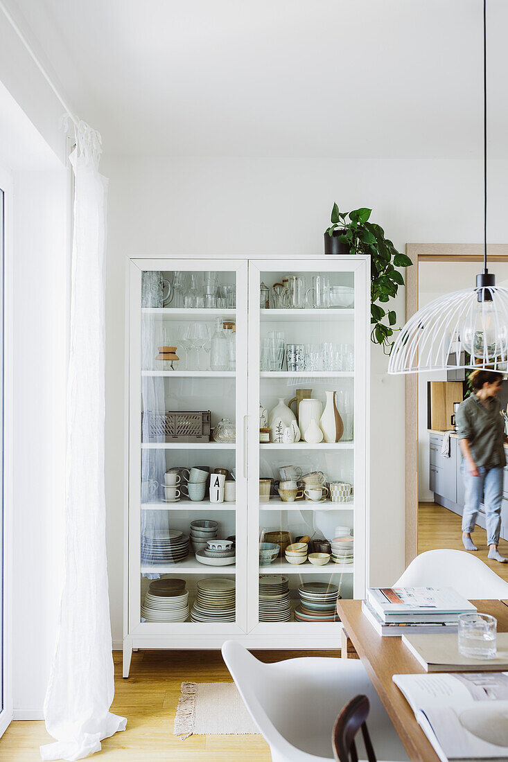 Display cabinet with crockery in Scandinavian-style living room