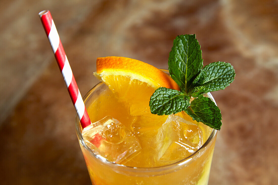 Orange lemonade with mint and ice cubes