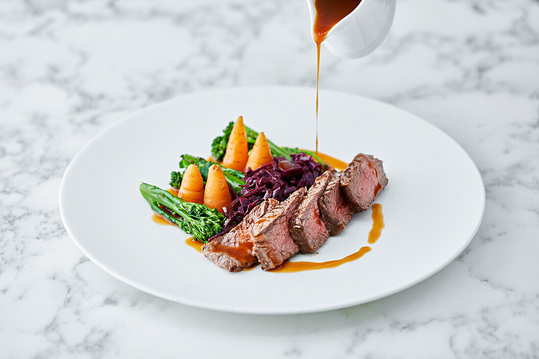 Roast beef with gravy being poured