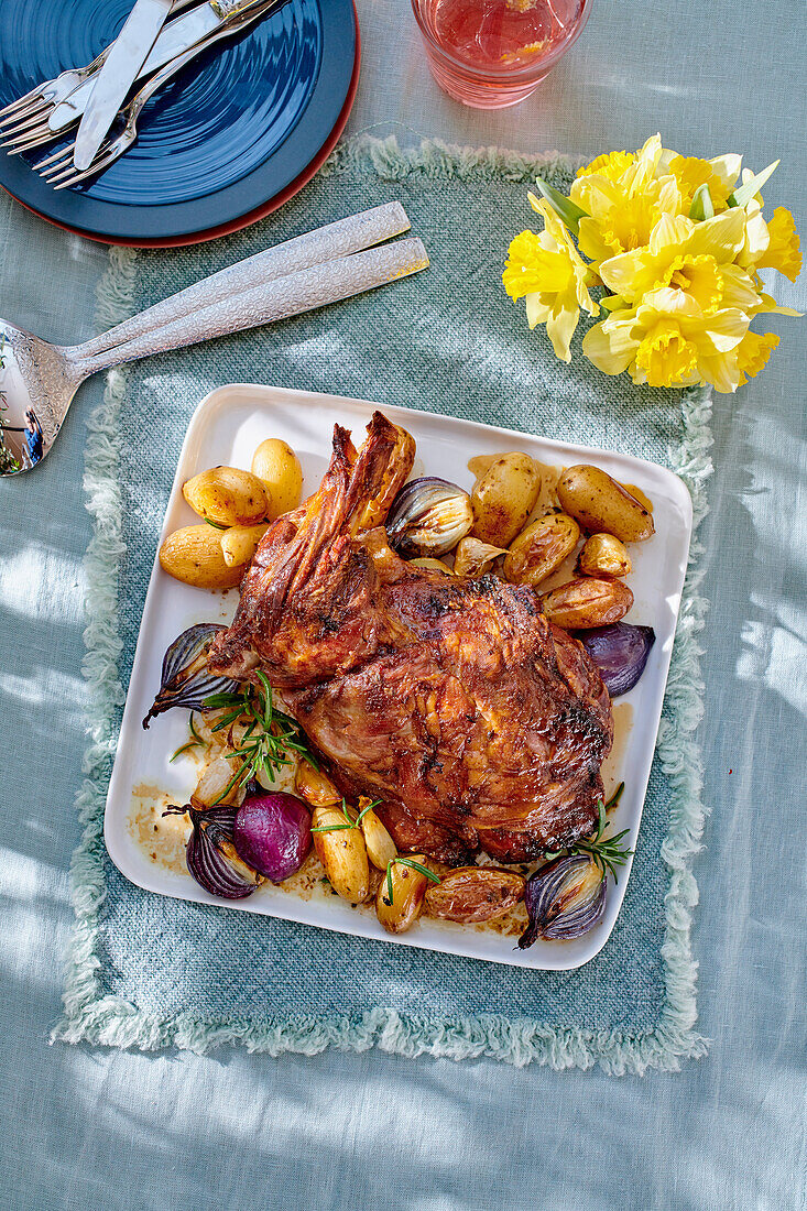 Roasted lamb shoulder with potatoes and red onions