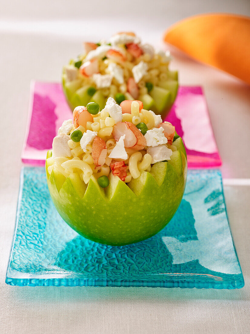 Pasta salad with feta served in a hollowed-out Granny Smith apple