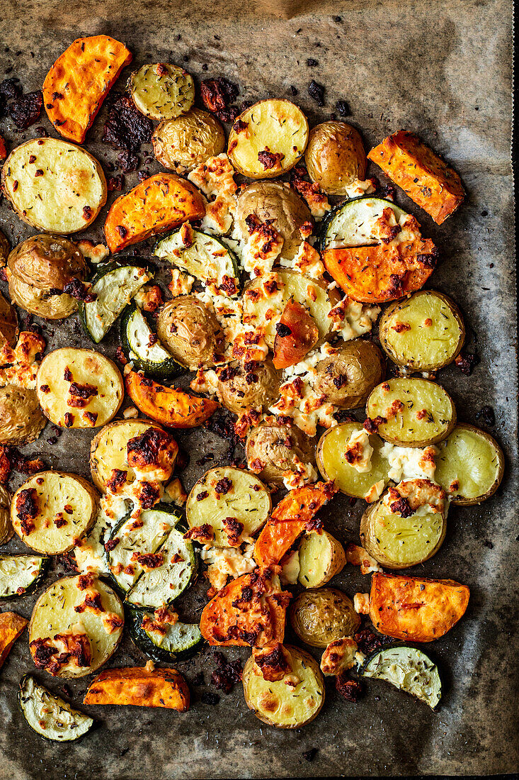 Baked potatoes with sweet potatoes, thyme, and feta