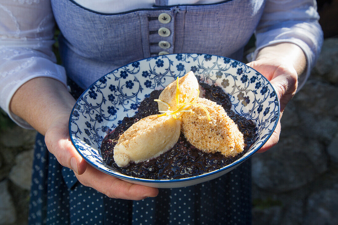 Serving airy curd cheese dumplings on elder compote