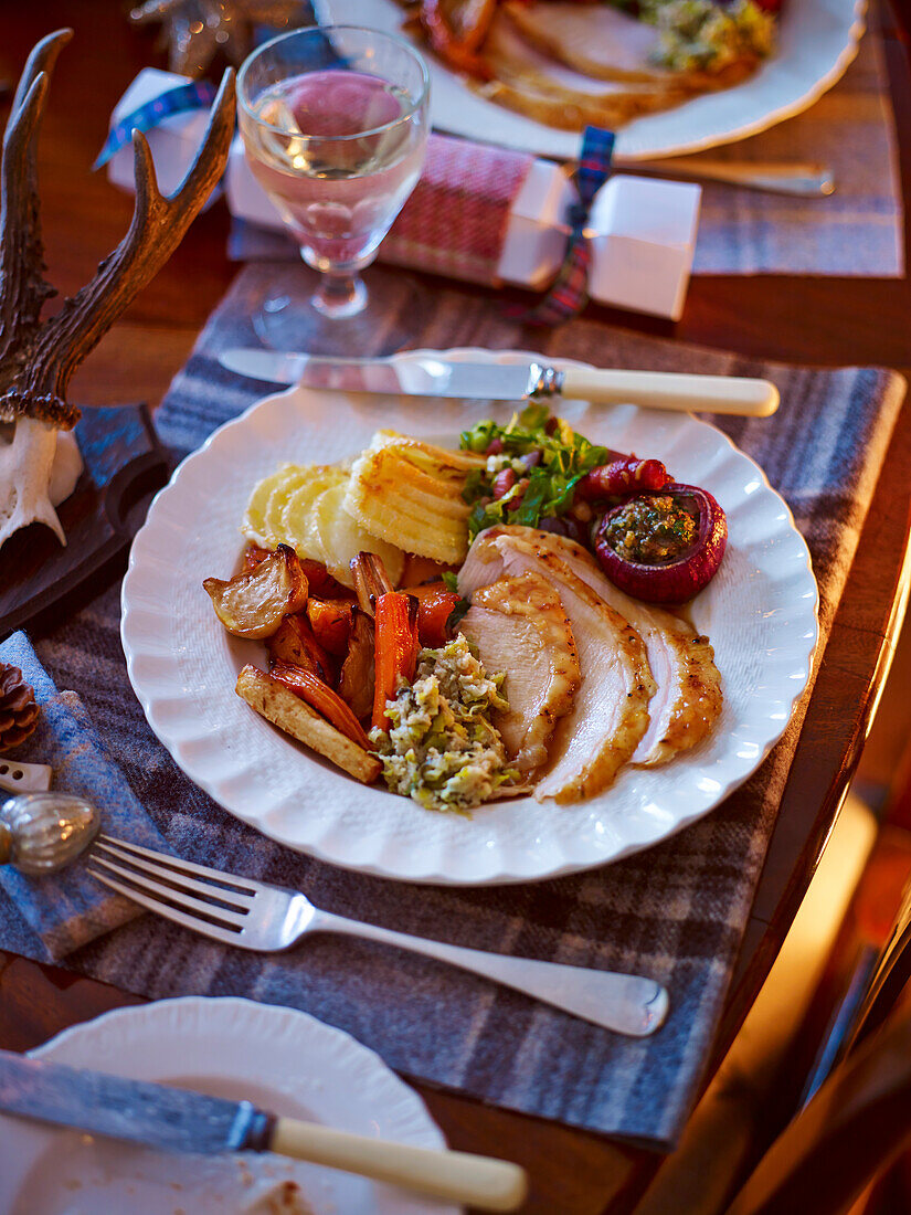 Bay leaf and lemon roasted turkey with butter and leek stuffing served at Christmas dinner