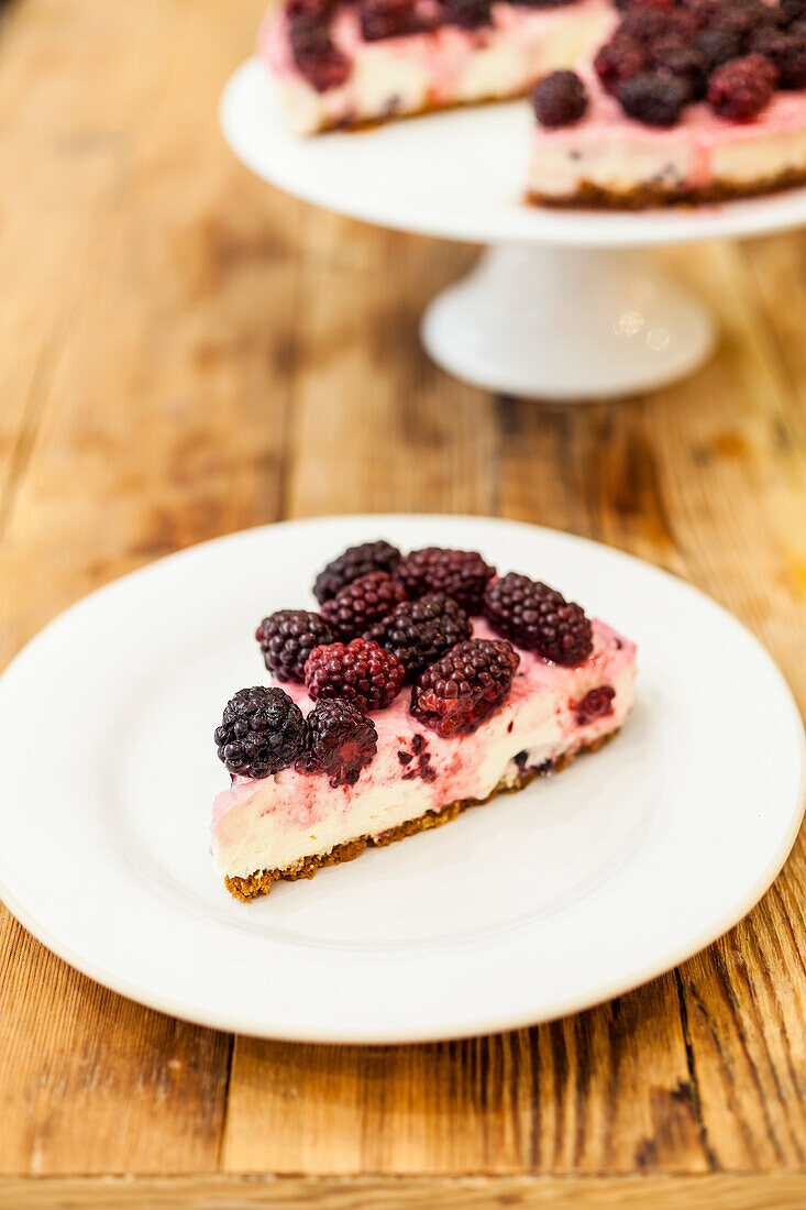 Blackberry cheesecake with poached blackberries and syrup