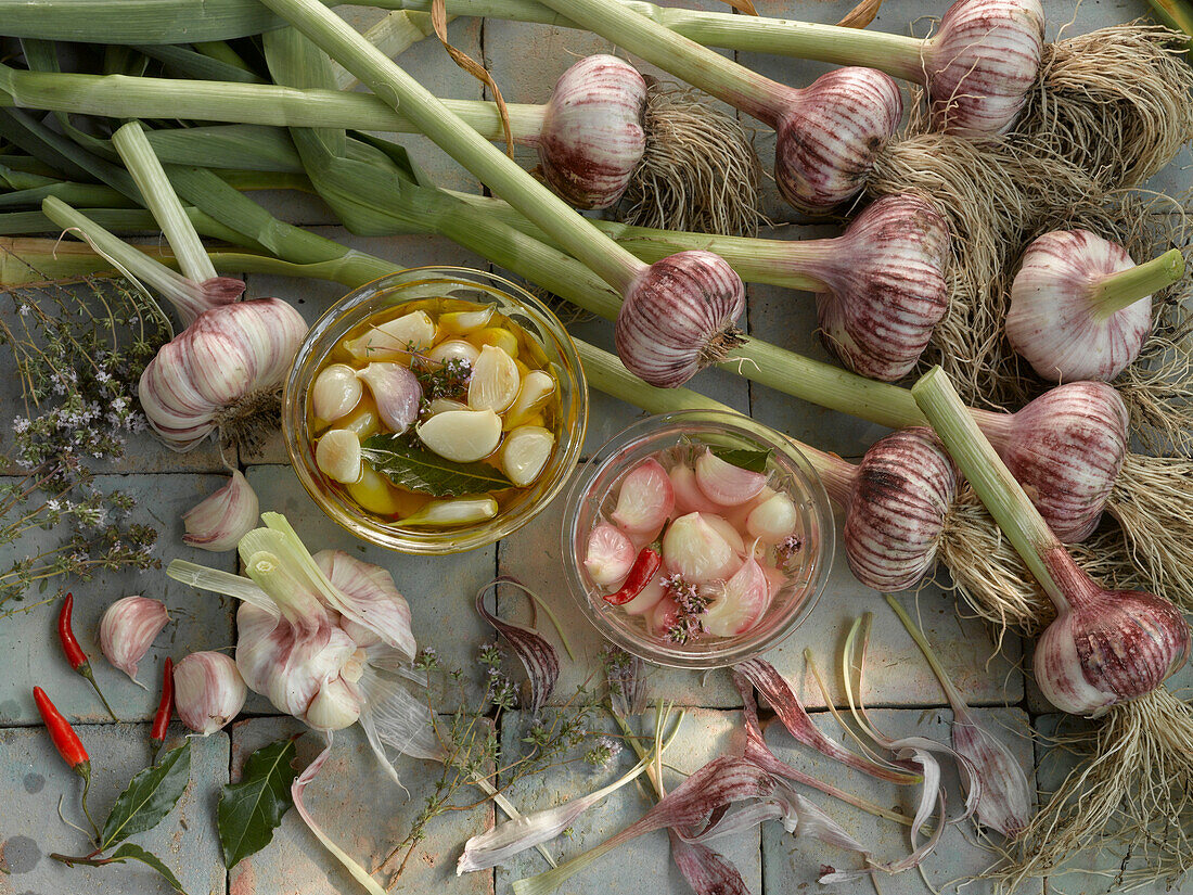 Still life with garlic, pickled garlic, thyme, bay leaf, and chili