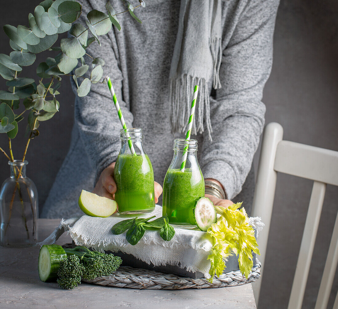 Two green smoothies with broccoli, cucumber, apple and celery