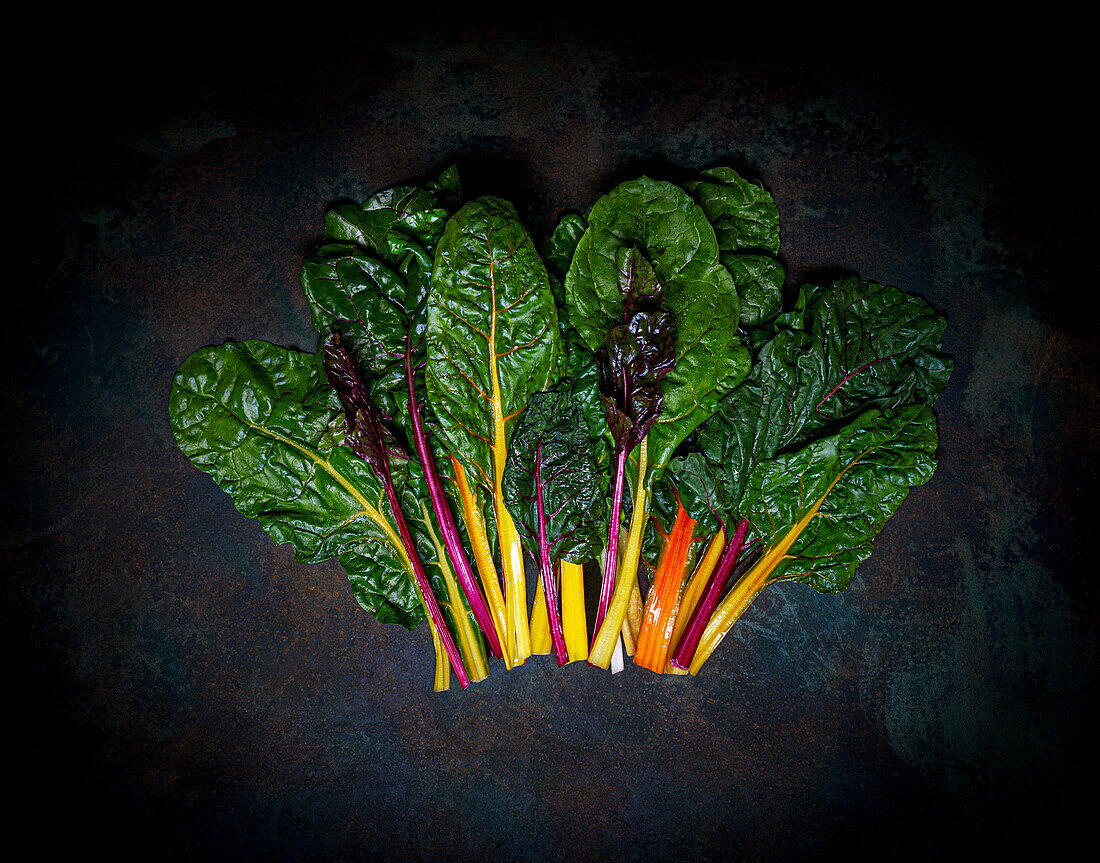 Fresh rainbow chard on a dark surface