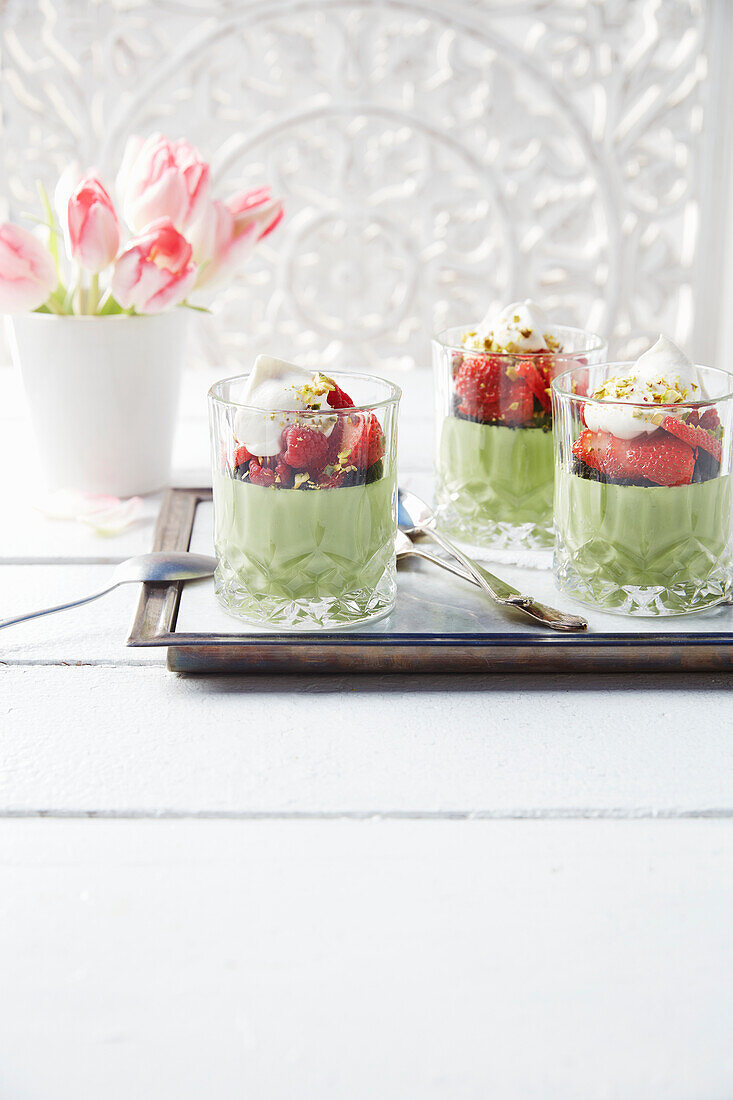 Mint matcha parfait with strawberries, blueberries and cream
