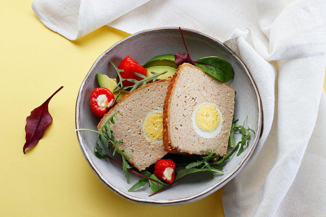 Meatloaf with boiled eggs on salad