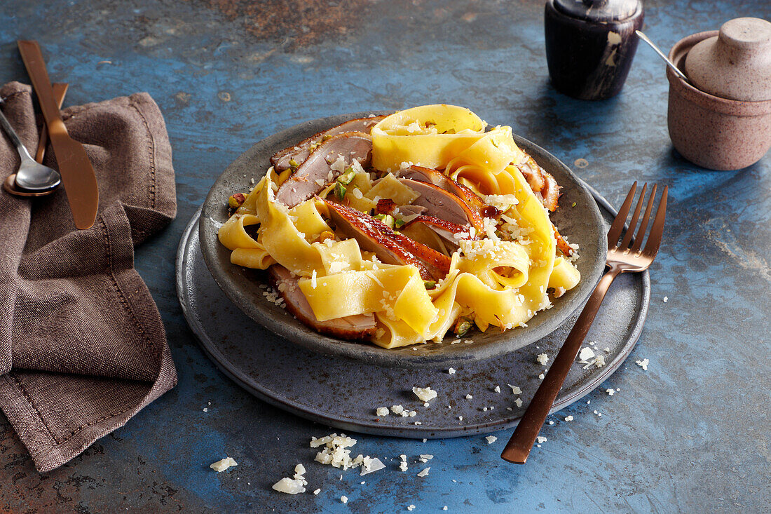 Tagliatelle with duck breast strips Parmesan cheese and crushed pistachios