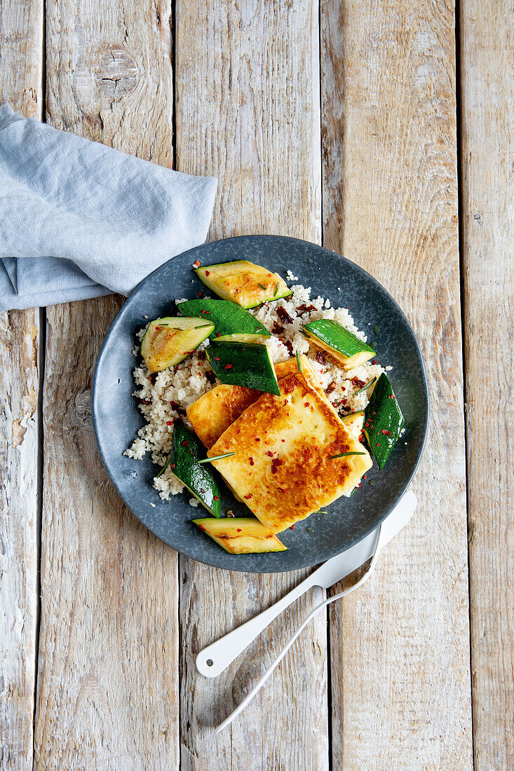 Halloumi served on couscous with rosemary and zucchini