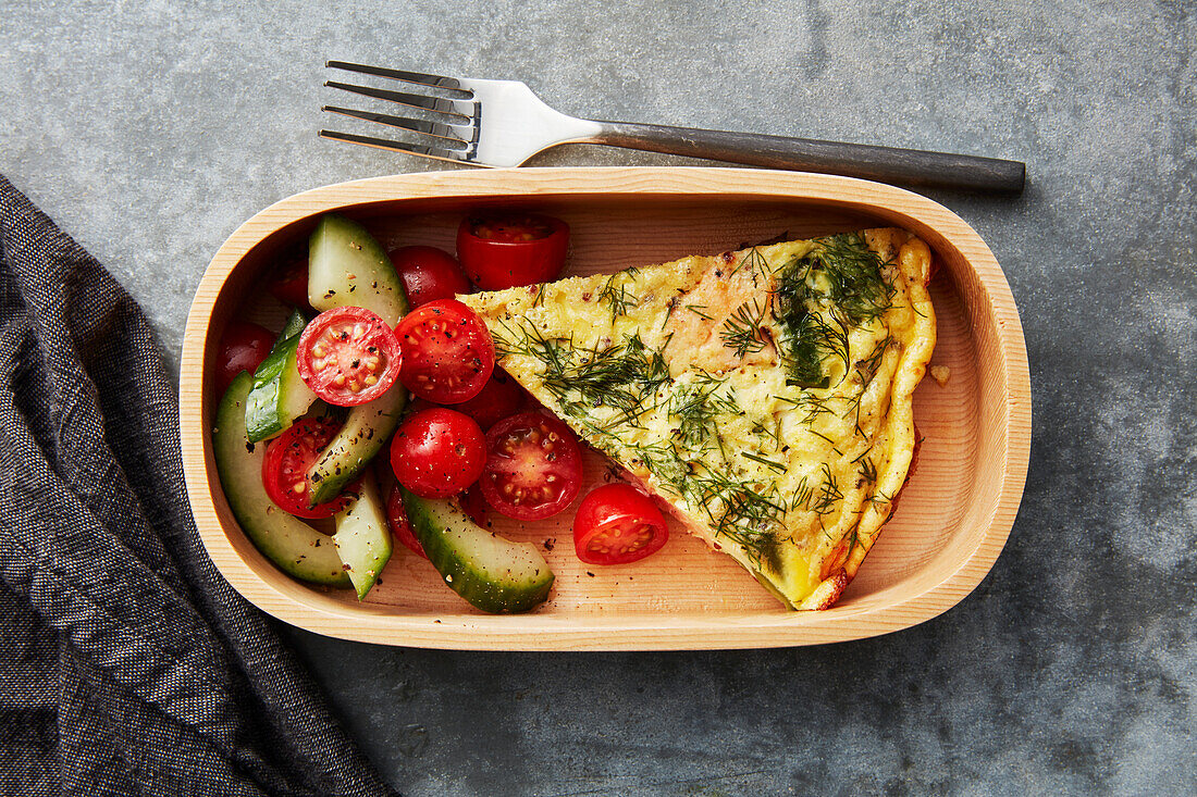Salmon frittata served with cucumber and tomato salad