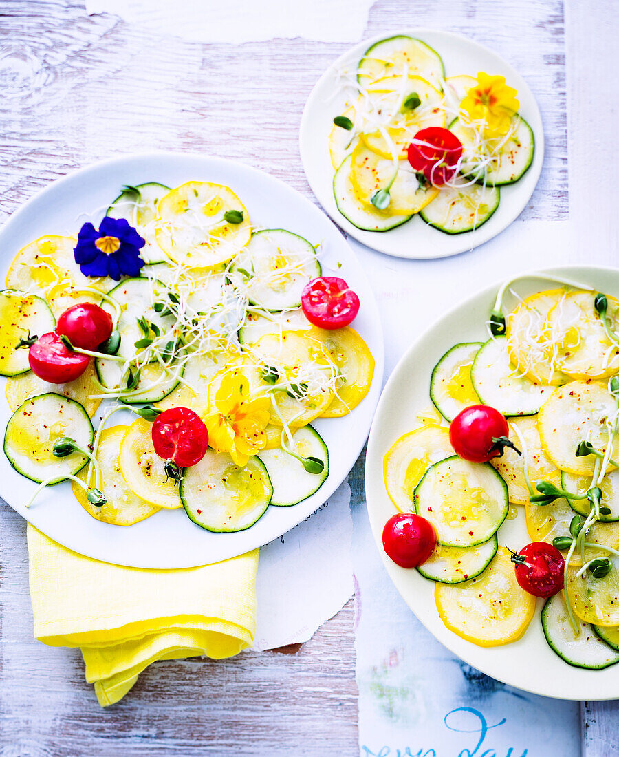 Zucchini carpaccio with flowers and cherry tomatoes