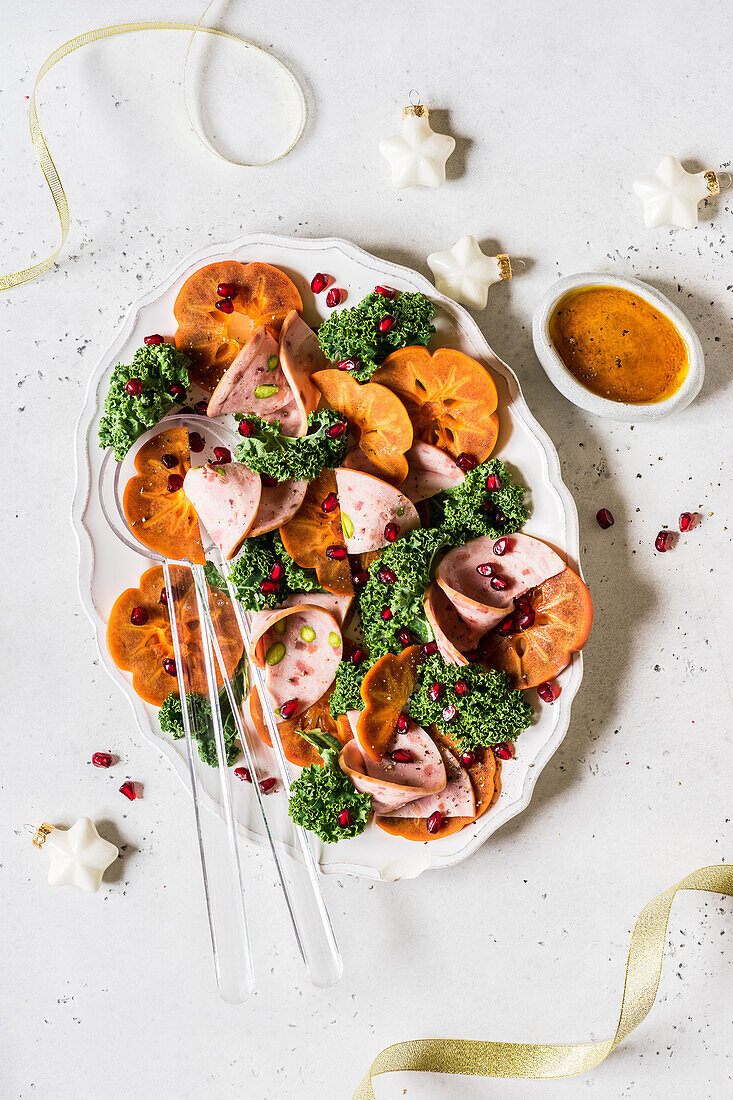 Christmas persimmon with kale, pomegranate seed and turkey pistachio ham salad