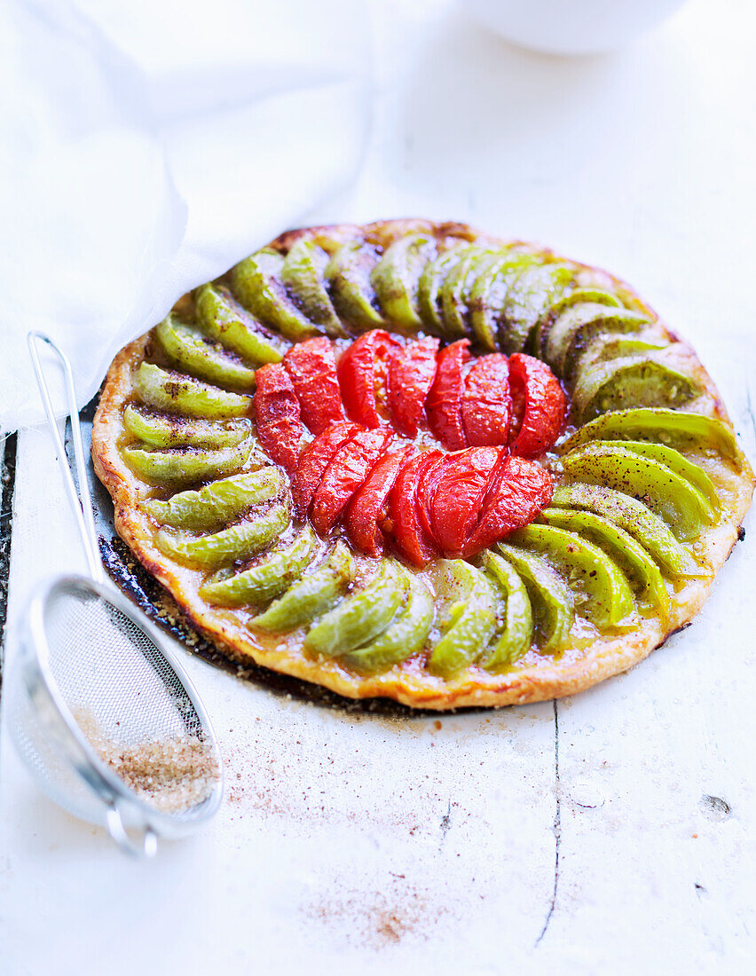 Puff pastry tart with green and red tomatoes