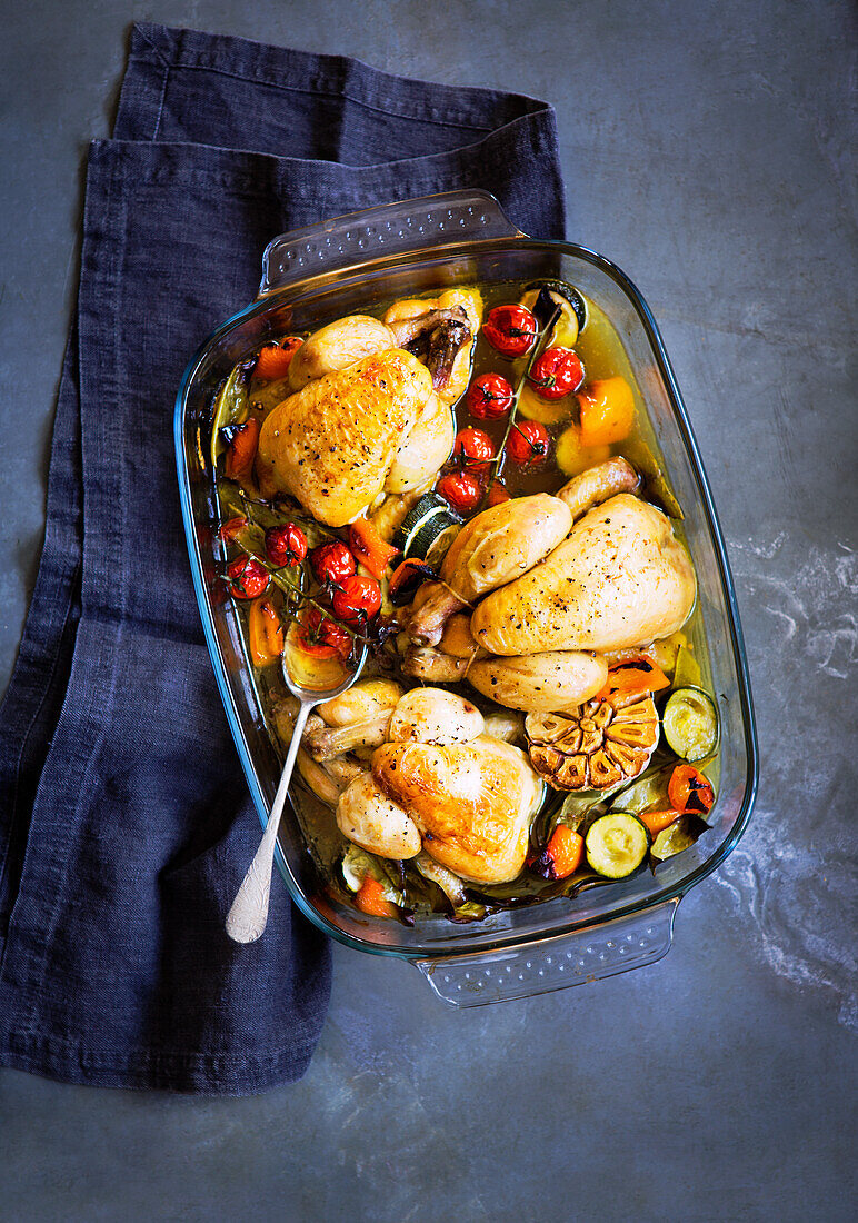 Roast chicken with preserved cherry tomatoes, roasted garlic and courgette