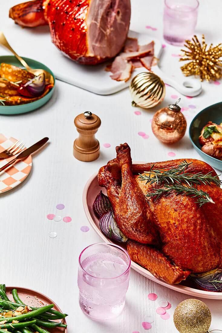 Christmas table with roast turkey and ham