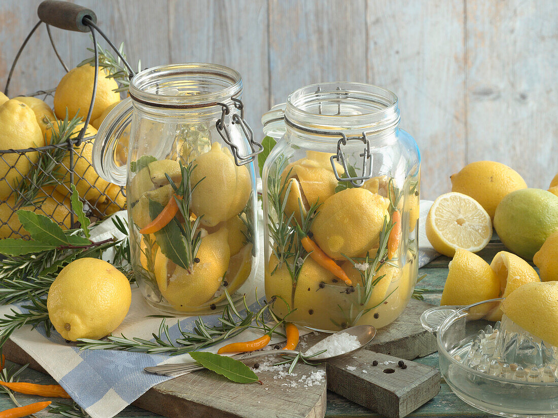 Lemons preserved in salt, with rosemary, chili, pepper, and bay leaf
