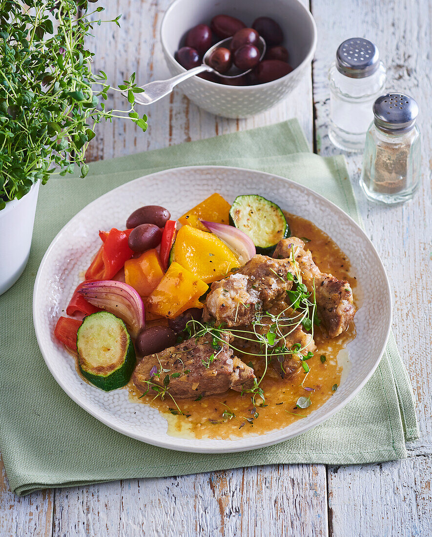 Thyme pork roast with vegetables and olives
