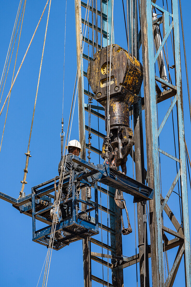 Derrickhand working in the rod basket on oil workover rig