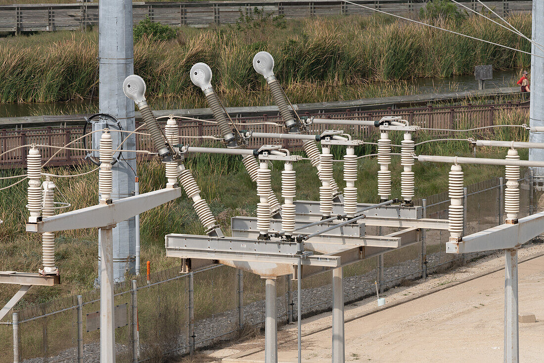 Load break interrupter attachments on an a power substation