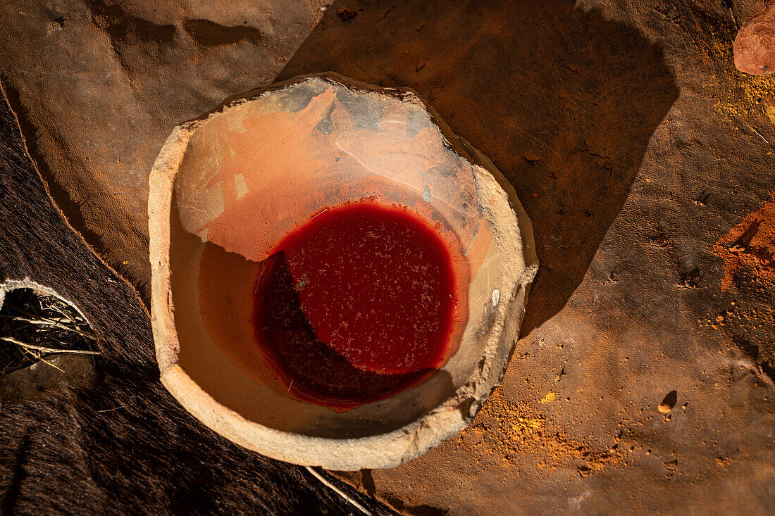 Crushed ochre pigment mixed with water