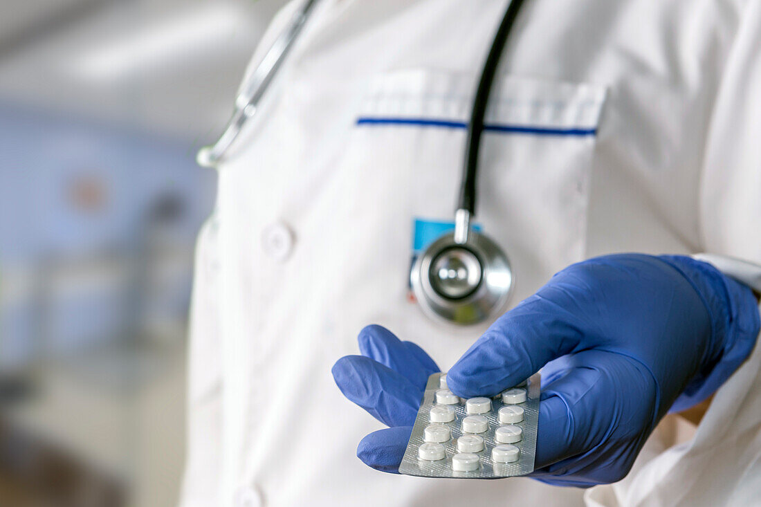 Doctor holding a pack of pills