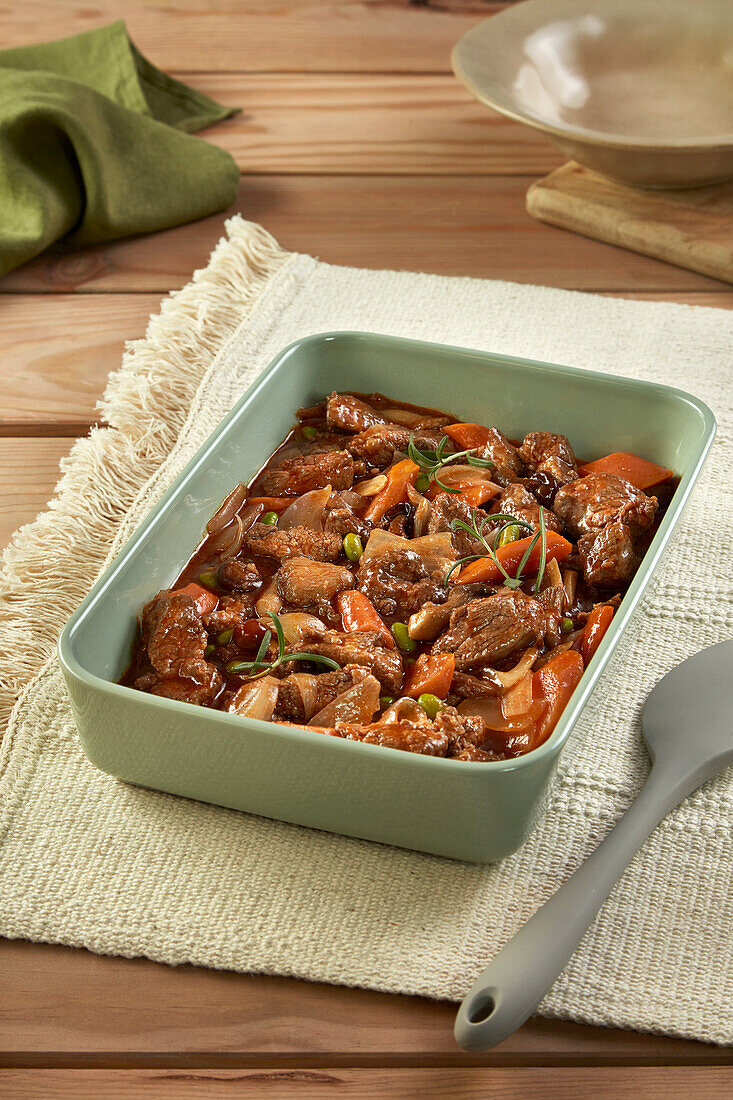 Stew with horse meat, carrots, rosemary and onions