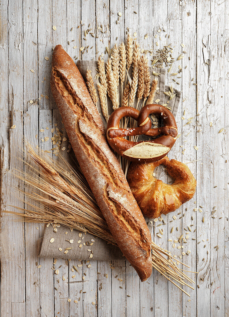 Baguette, pretzel, and croissant with ears of wheat
