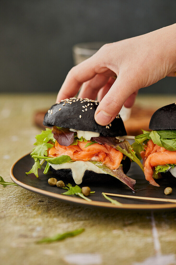 Black burger with fresh salmon