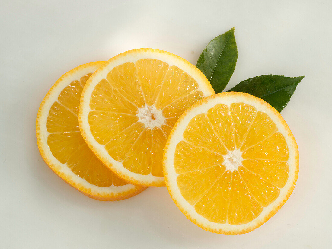 Three orange slices on a light background