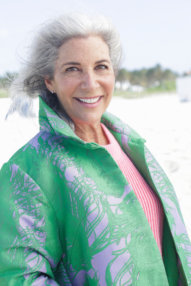 Gray-haired woman in a green coat