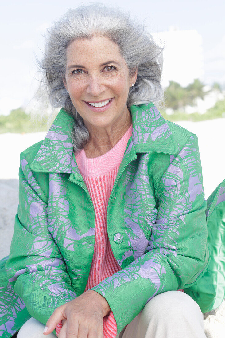 Gray-haired woman in a green coat