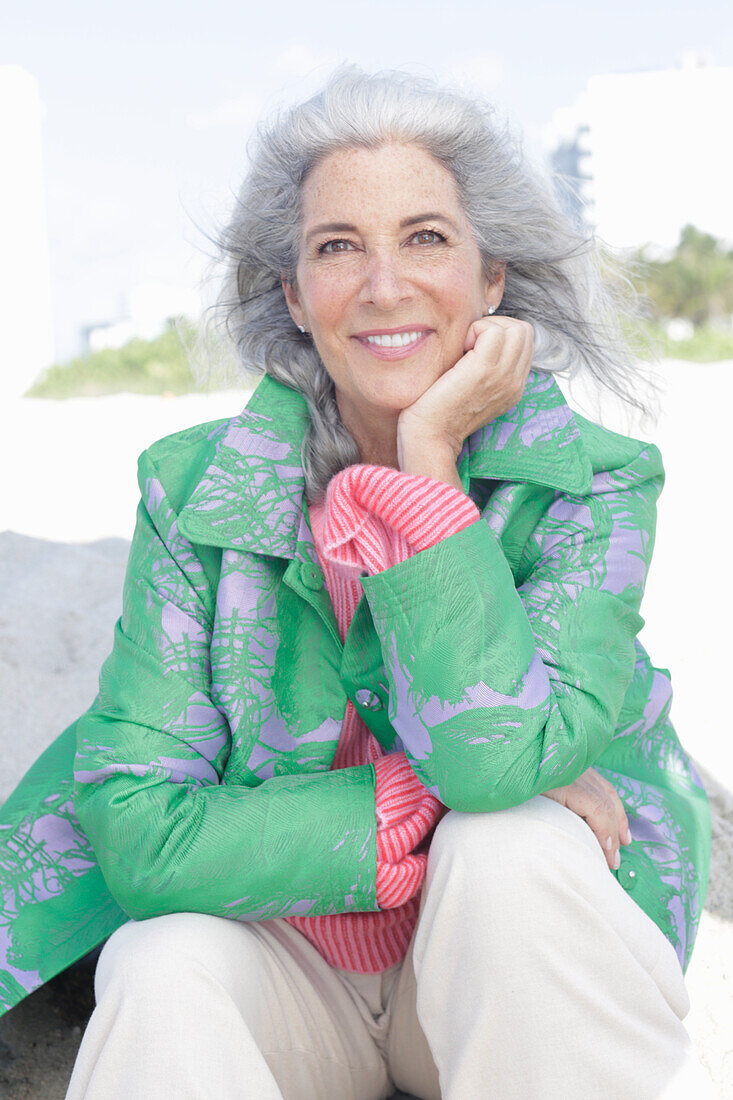 Gray-haired woman in a green coat