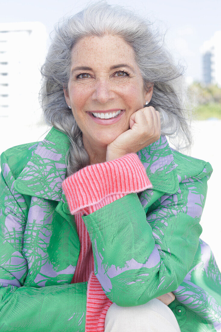 Gray-haired woman in a green coat