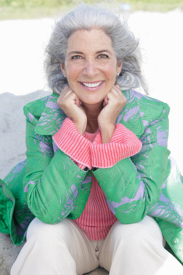 Gray-haired woman in a green coat