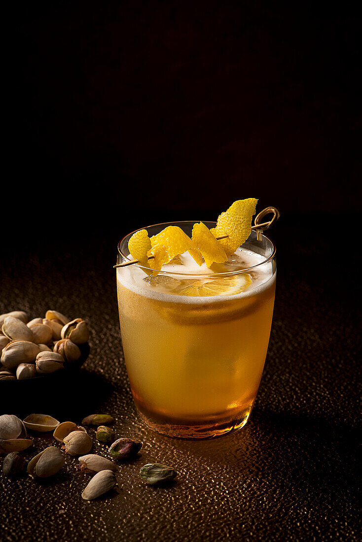 Whiskey sour cocktail with lemon